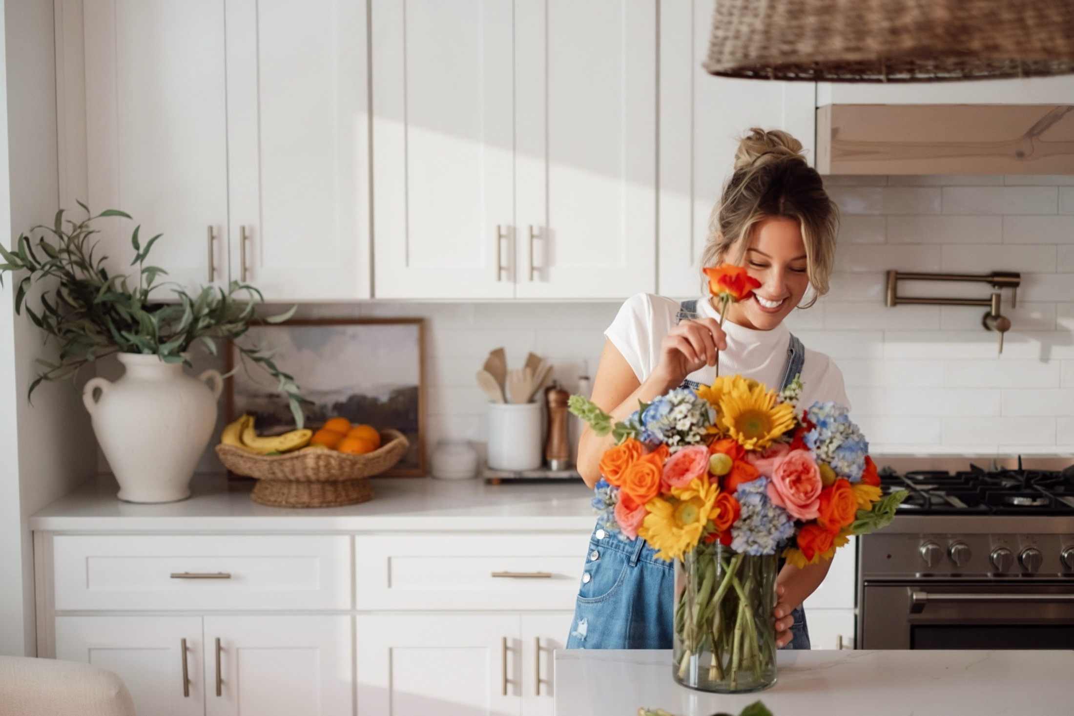 Sunday House florist arranging flowers in kitchen