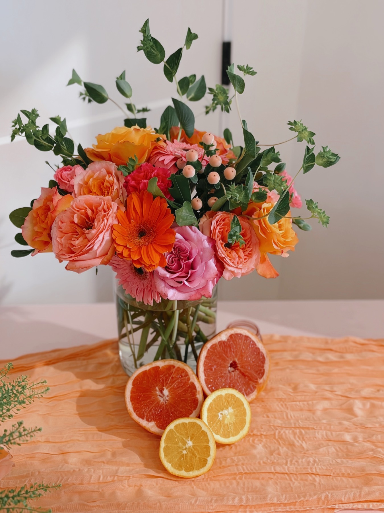Coral and orange citrus-themed bouquet with grapefruit slices